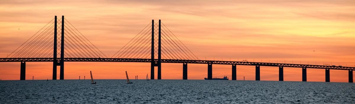 Silhouette photo of Bridge of Öresund in sunset.