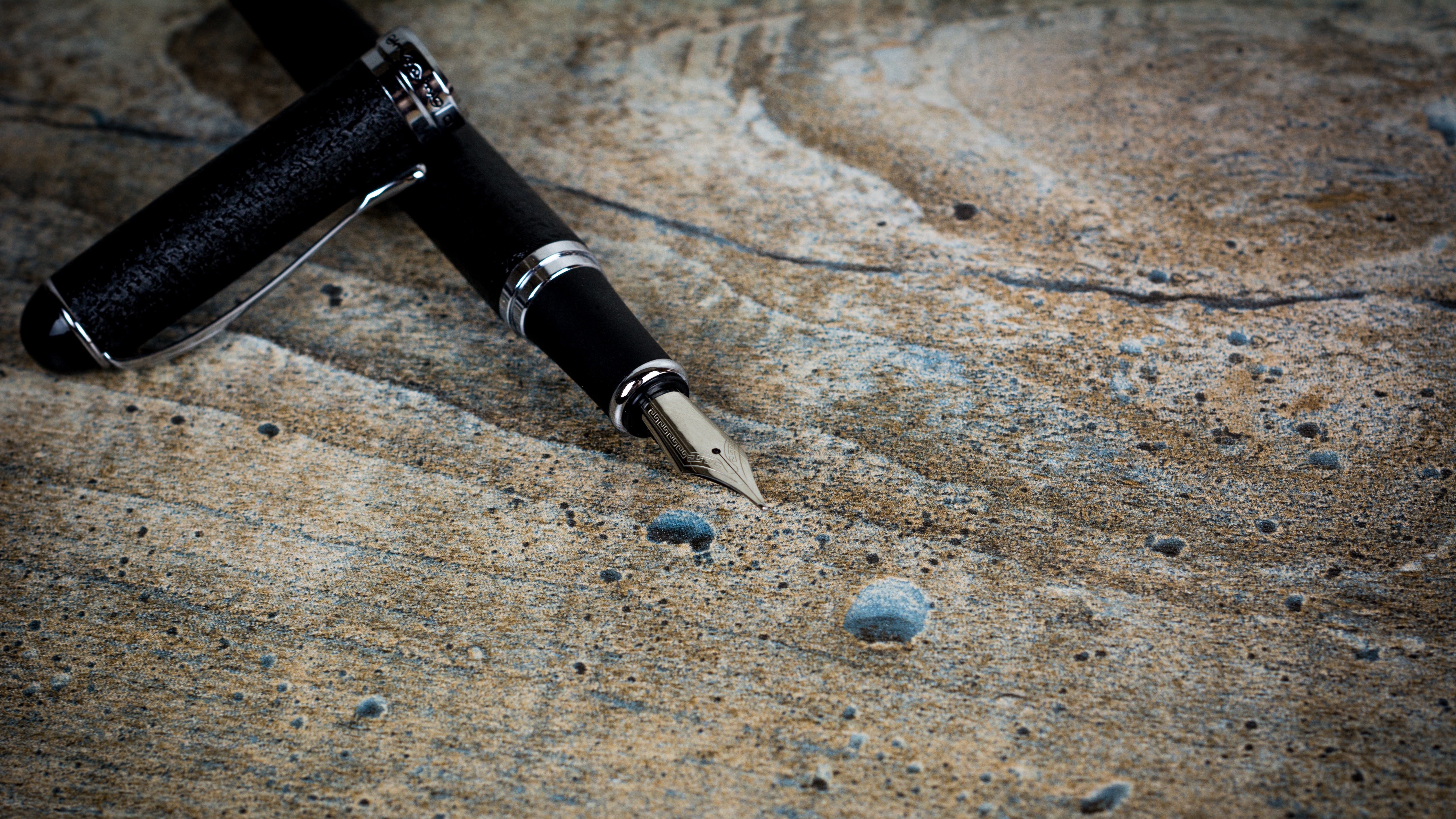 Fountain pen laying on a wooden surface